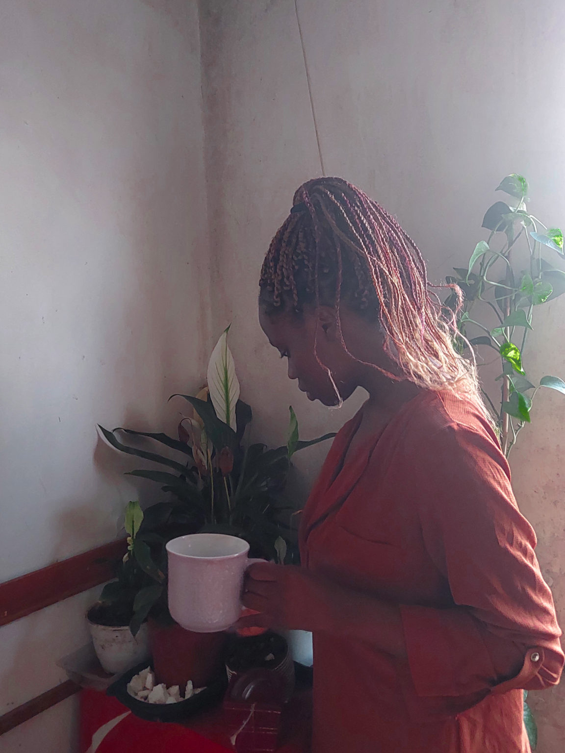 woman caring for plants in a corner of the house