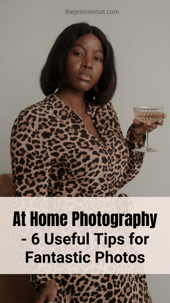 woman holding a wine glass while staring at the camera