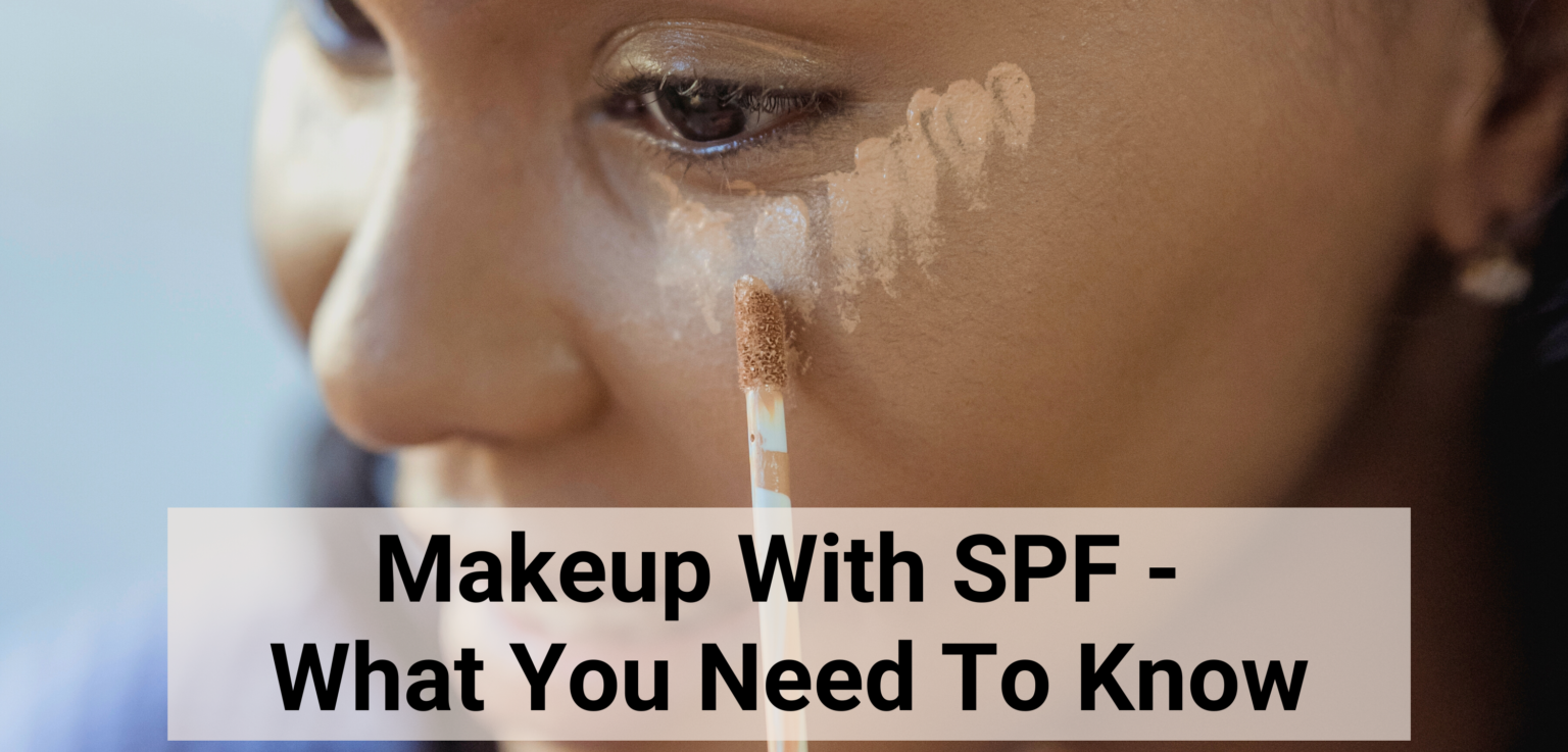 black woman applying makeup with SPF under her right eye