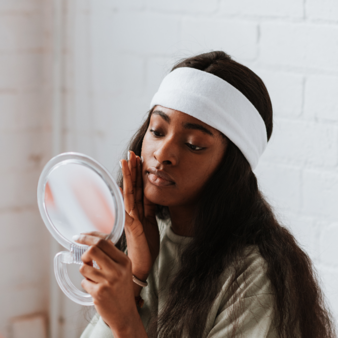 what is a serum - woman looks in the mirror and applies a face cream