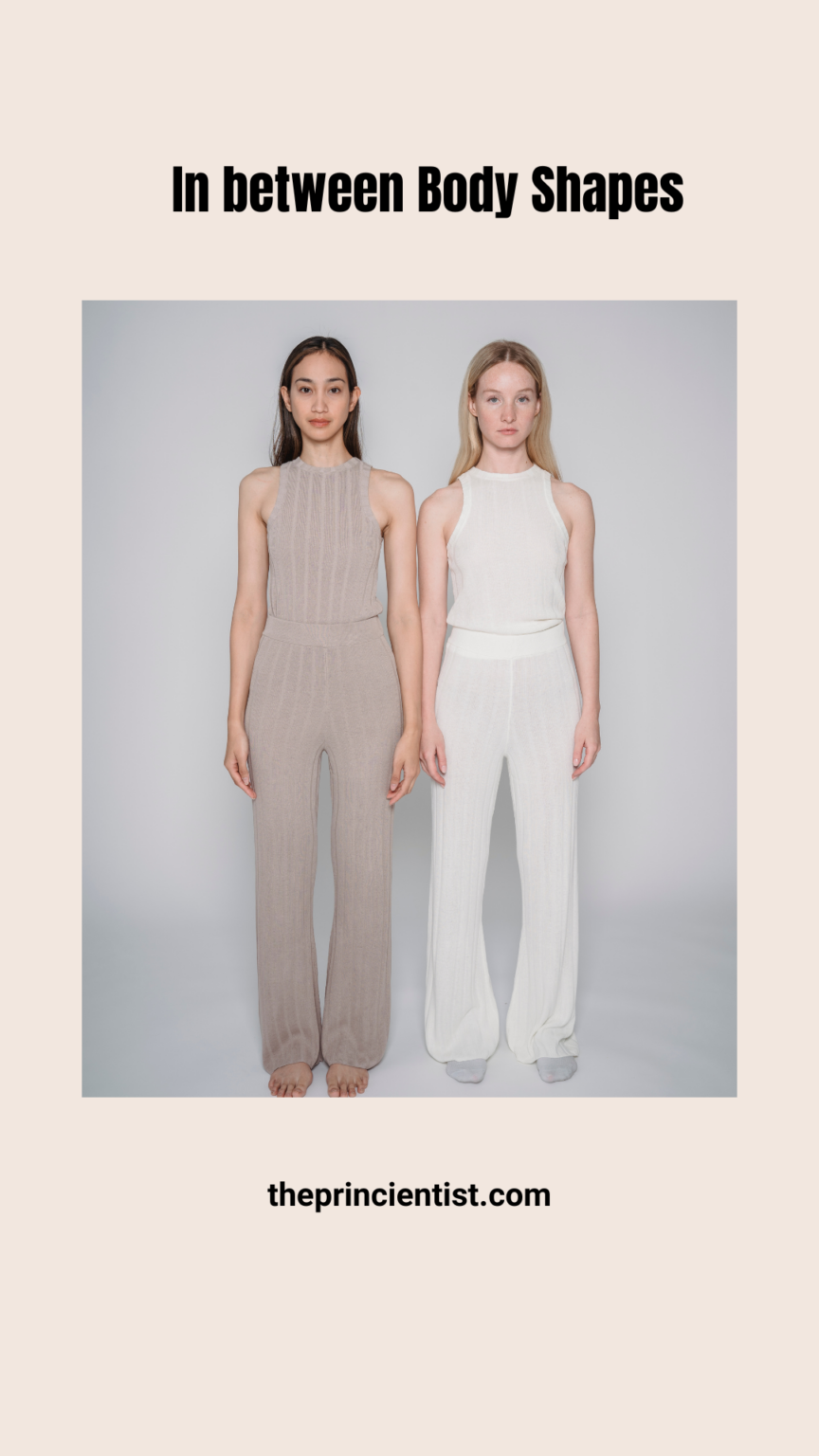 two woman standing with their arms down and head straight. t